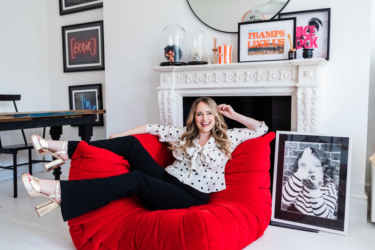 Chantelle laughing on a red sofa